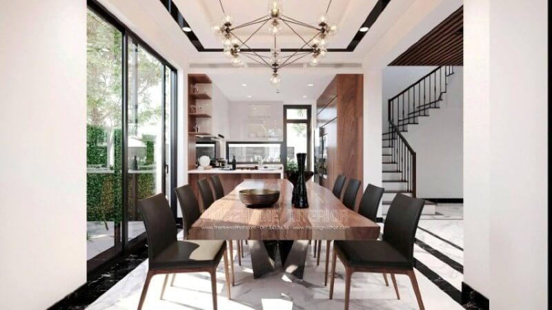 Bàn gỗ óc chó nguyên khối tạo điểm nhấn ấn tượng trong sắp xếp nội thất phòng ăn.